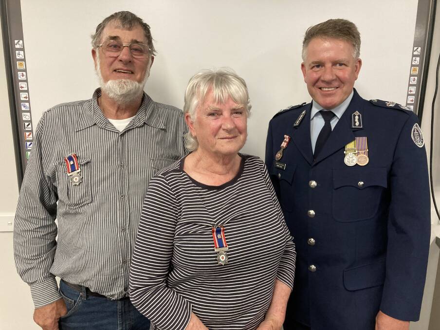  Honour: Graham and Karen Robinson and CFA Deputy Chief Officer Graham Cook. Picture: CONTRIBUTED. 
