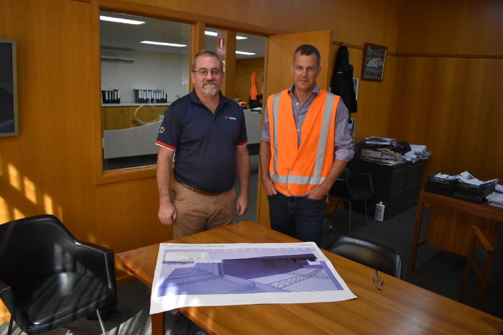 PLANS: Managing Director Wayne Gason and CFO Leon Nash looking over the blueprints for the new facility. Picture: JAMES HALLEY. 
