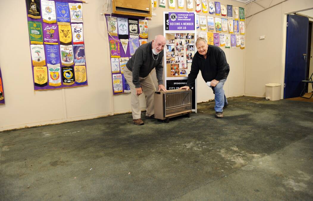 FLOOD REPAIR: Allan Henderson and Bill Deleeuw cleaning up Horsham City Lions Club rooms after water flooded it. Picture: PAUL CARRACHER 