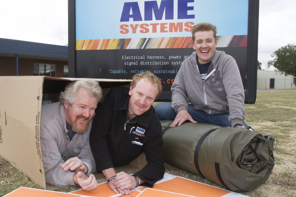 SLEEPING OUT: Steve Rodis (HR & D Coordinator), Luke Bannister (Social Club President) and Nick Carthew (Managing Director) at AME Systems. Picture: PETER PICKERING. 