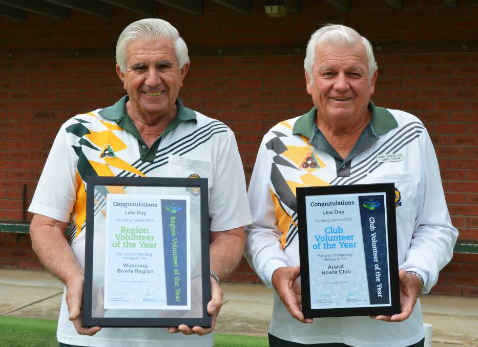 Lew Day is presented with his two awards by Ararat Bowls Club president Lawrie Tonkin. Picture: CONTRIBUTED. 