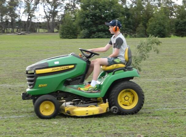 WORK TO BE DONE: Bailey Hosemans shows how it's done at the winter solstice mower muster on the proposed site for the Wildlife Art Museum of Australia between Halls Gap and Pomonal. Picture: Contributed.