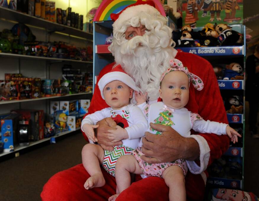 HO HO HO: Ararat twins Max and Evie Seebohm were lucky enough to get a special visit from Santa at Toyz on Barkly on Wednesday. Picture: SAMANTHA CAMARRI. 