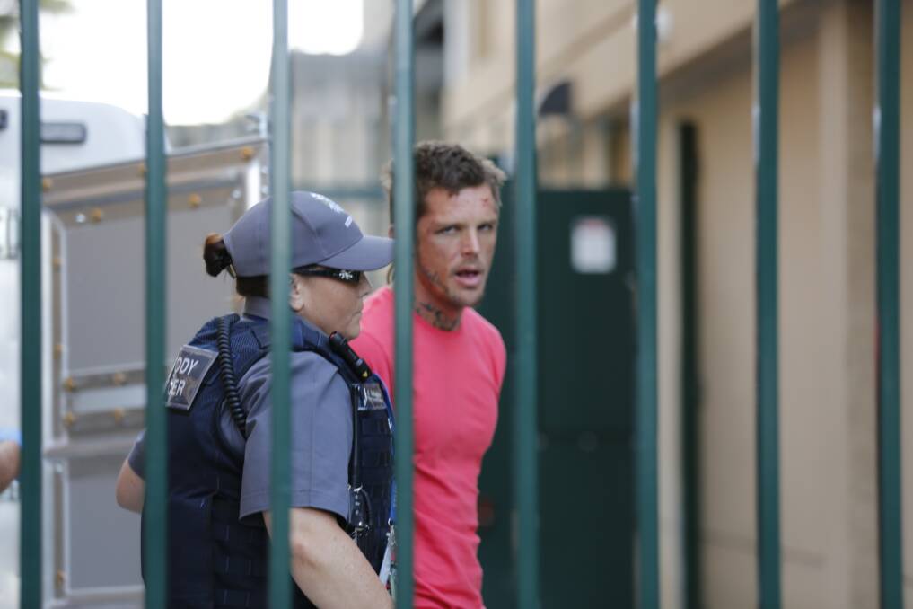 Kayd Thorp is led into the Bendigo Magistrates' Court by a police custody officer on Wednesday.