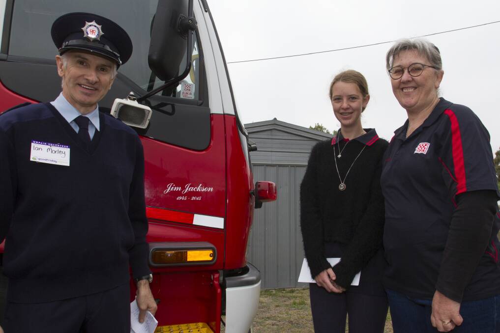 Recognition: Ian Morley at the truck dedication with Jim Jackson's family Janine and Caitlin Benson. Picture: Peter Pickering.