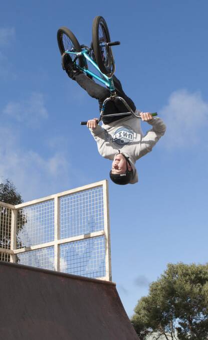 UPSIDE-DOWN: Marcus Johnston shows off his aerial skills on his bike at the Ararat Skate Park. Picture: PETER PICKERING