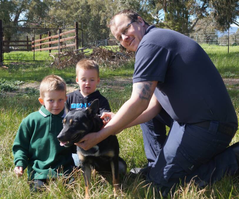GENEROUS: Lowan and Draylan Gregory with Ararat Rural City Council local laws officer Leigh Jeffery and one of Ararat pound's rescued dogs.