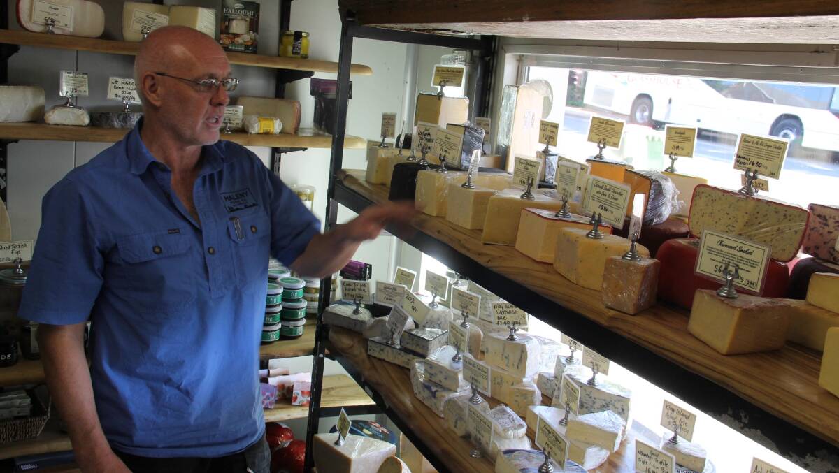 Norman Scott among his cheeses … loves life in Maleny. 