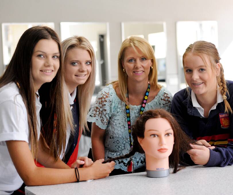 Hair and beauty: Stawell Secondary College year 11 students Heidi Chatfield, Molly-Rose Cameron and Kasey Bibby-Rickard with teacher Sonya Seehusen.