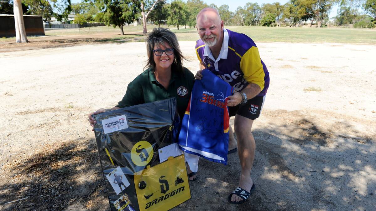 Horsham Agricultural Society secretary Andrea Cross and Relay For Life chair-manager Kingsley Dalgleish with some of the auction items. 