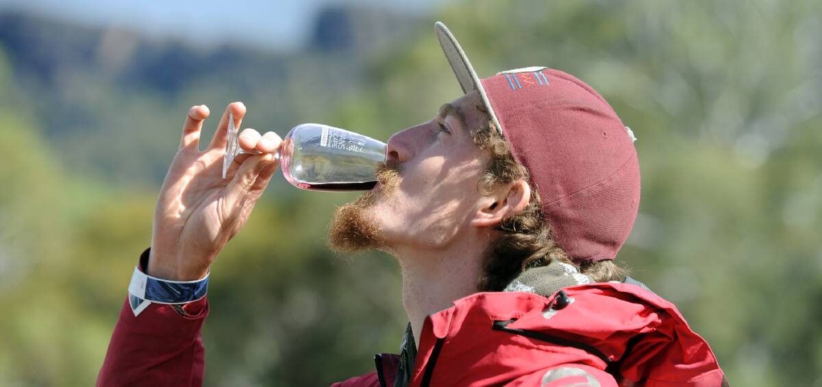 FINE WINE: Braeden Hyland enjoys a tipple at the 25th Grampians Grape Escape at Halls Gap. More than 7000 people attended the event. Picture: PAUL CARRACHER