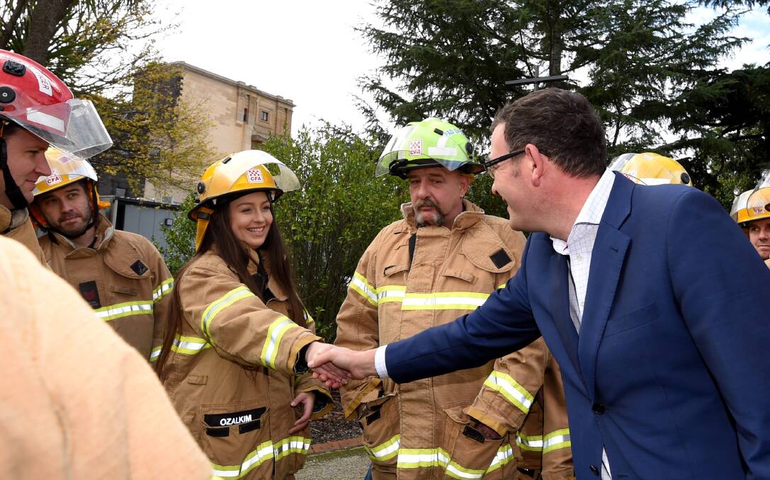 Premier Daniel Andrews with firefighters. Picture: LUIS ASCUI