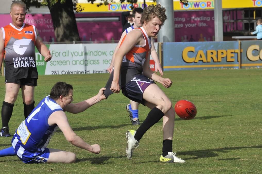 Grampians Giants' Brad Greene attempts to slip away from his Hamilton opponent while Mark Fogerty watches on. The Giants recorded a nine-point victory on Saturday, defeating Hamilton Boomers at Melville Oval. Picture: ROBYN AGNEW, Hamilton Spectator 