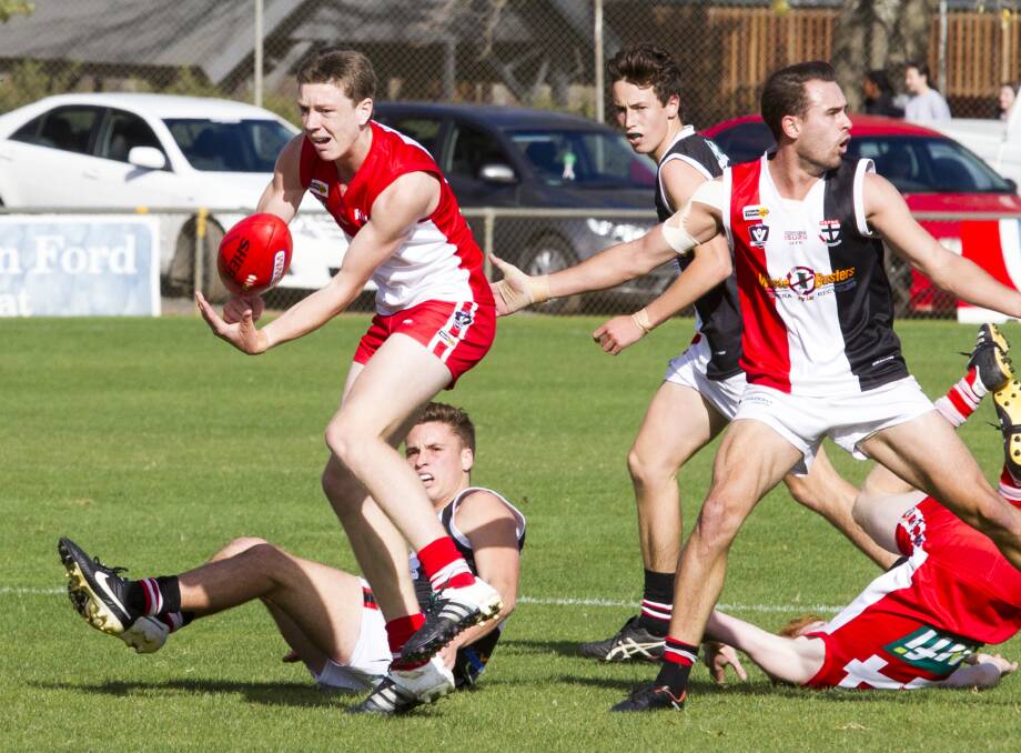 LOOKING: Ararat's Tom Mills hand passes out of trouble last weekend against Horsham Saints. Mills is in the Rats' brigade of youngsters coming through the senior ranks in season 2016. Picture: PETER PICKERING 