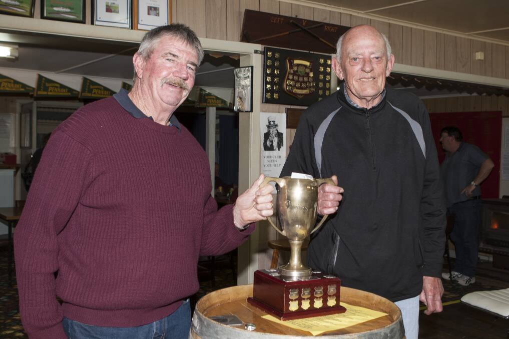 Aradale captain Gary Cooper is pictured presenting the Pyrenees Cup to Willaura Golf captain Harry Little. Picture: PETER PICKERING 