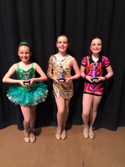 DYNAMOS: Dancers Jenae Marr, Emma Lavery and Bonnie Mellor proudly hold their spoils. 