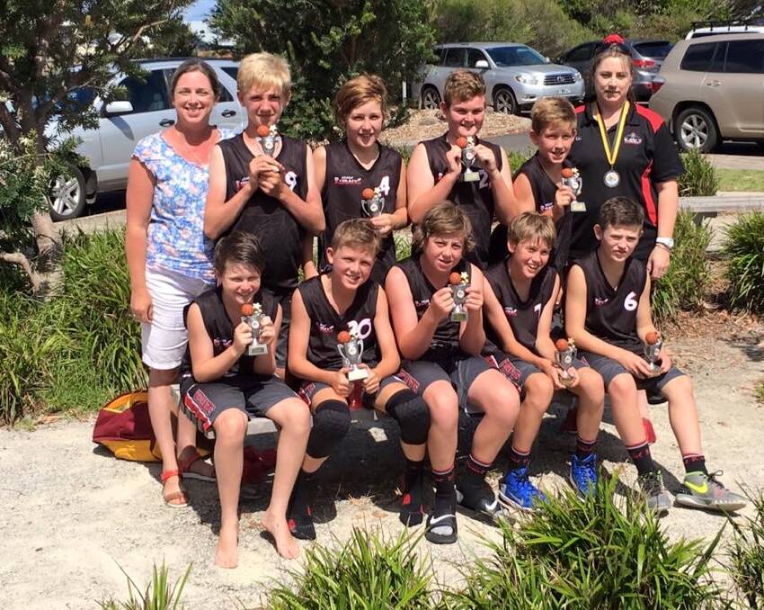 The grand final-winning under 14 Redbacks team with team manager, Romaine Lawrie.   
