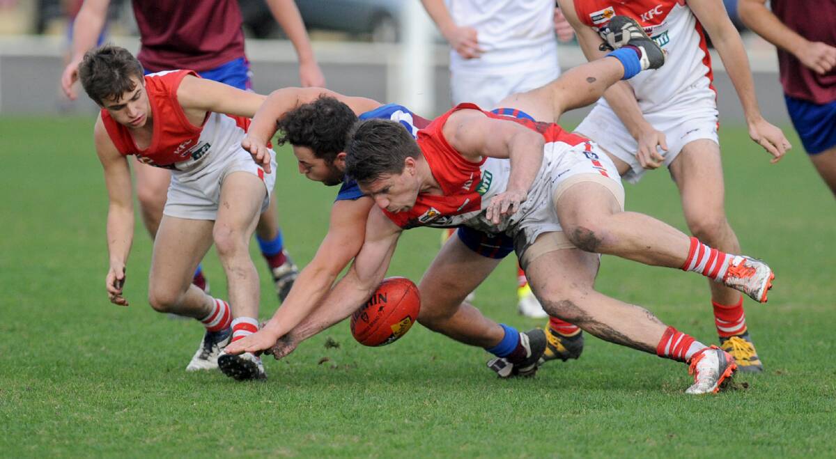BODY WORK: Ararat's Daniel Mendes uses his body to out-muscle Horsham's Baillie Batchelor for a loose ball in the Demons clash against Ararat.