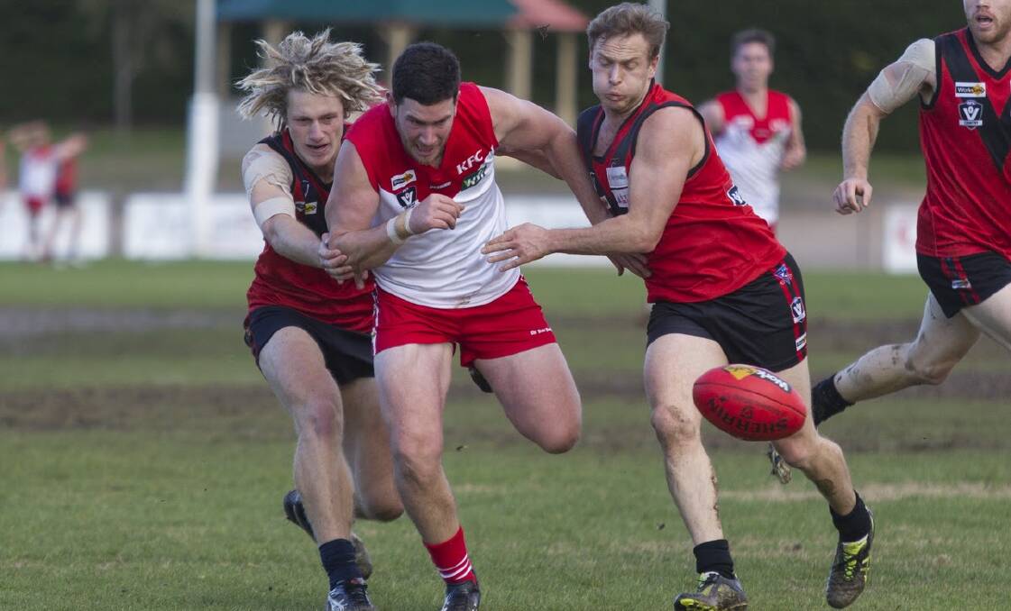 UNDER PRESSURE: Ararat's Lachie Hamilton gets some close attention from Stawell's Jackson Dark and Aidan Potter. Picture: PETER PIKCERING