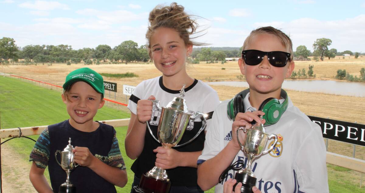 Giveaways: Sebatian, Tiarna and Brayden Barry show off sunglasses, a hat and head phones supplied by Country Racing ahead of the Great Western Cup. Picture: Peter Pickering