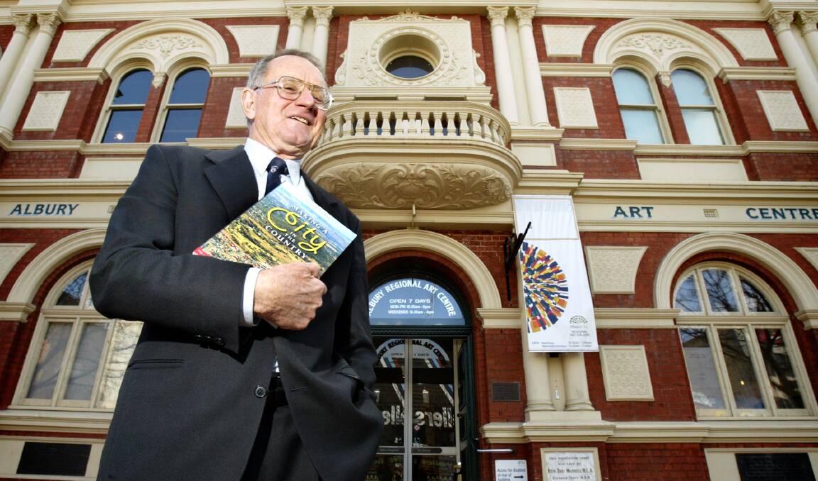 Flashback: Bruce Pennay in 2005 with one of his books. He wants the Hume and Hovell plaque on the former Albury Town Hall to have an Aboriginal acknowledgment. It can be seen in the background in the left-hand corner of the photograph.