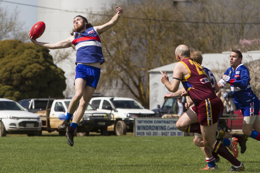 STRETCH: SMW Rovers' Tim Peart takes a nice mark ahead of his Glenthompson-Dunkeld opponent. Picture: Peter Pickering