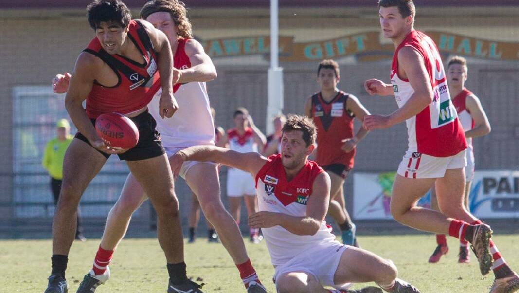 Tom Taurau looks to get the ball away during a previous Ararat v Stawell match. The two teams will again clash on Good Friday with the Rats to host the 2018 clash.