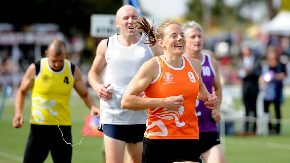 SMILES: Anne Fiedler, orange, takes out the Sertori & Co Masters' Handicap 300 metres final at the 2017 Stawell Gift.