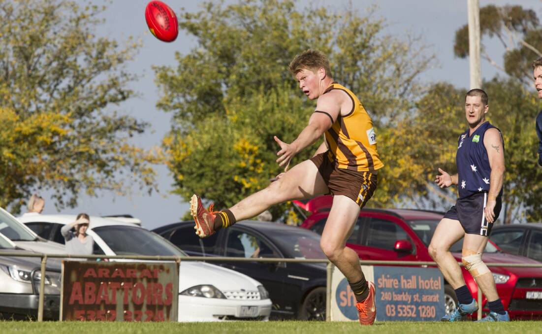 REBOUND: Tatyoon's Sam Thomson gets his kick away in round one against Ararat Eagles. Picture: Peter Pickering