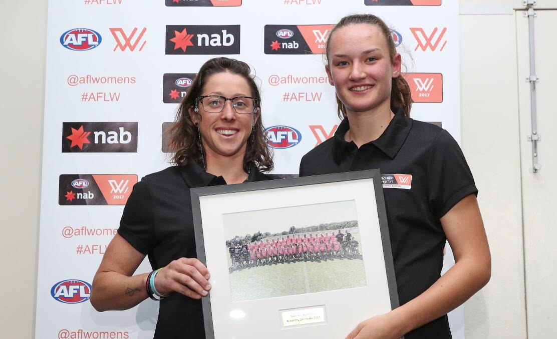 HONOUR: AFL Women's Academy assistant coach presents Georgia Clarke with her academy photo.