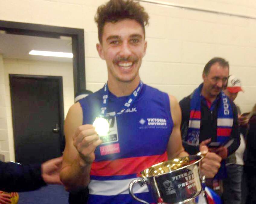 CHAMPION: Lauchie Dalgleish is all smiles with his premiership medal and the VFL cup after Footscray beat Casey Scorpions on Sunday.