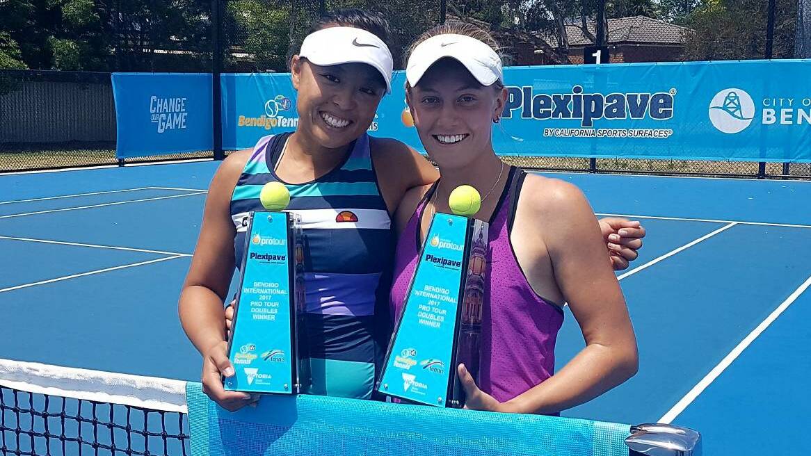DELIGHTED: Zoe Hives and Alison Bai with their ITF Bendigo doubles title trophy. The Pair have now qualified for the Australian Open.