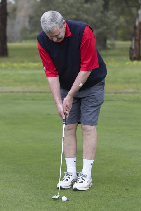 Steve O'Connell lining up his putt on Saturday. Picture: Peter Pickering