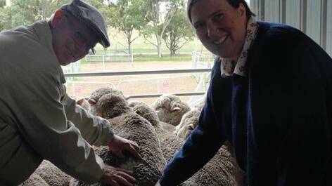 Inspection time: Australian Superfine Wool Growers Association annual reunion and fleece competition attendees Tony Gall and Penny Hartwich inspect a sheep. Picture: provided. 