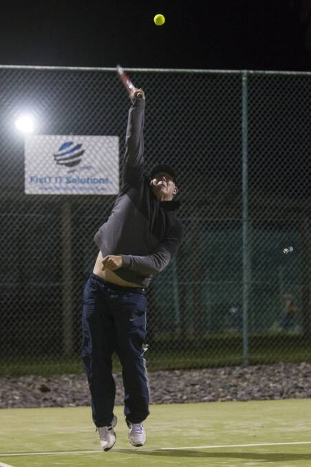 Aiming High: Marcus Matthews of the Ararat City Tennis Club on Wednesday night, returning to play on the courts after they were washed out last week. Picture: Peter Pickering. 