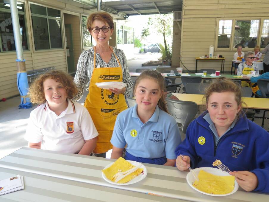 TOP SERVICE: Donna Newell serves Miles Fraser, Matilda Venn and Toiya Atchison their pancakes at Pomonal earlier this week.