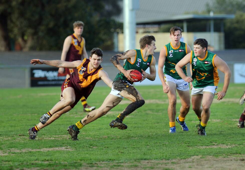 SPEED: Dimboola Roo Ben Miller breaks away from Warrack Eagle Harry Trezise in round 11 of the Wimmera Football League. Picture: PAUL CARRACHER