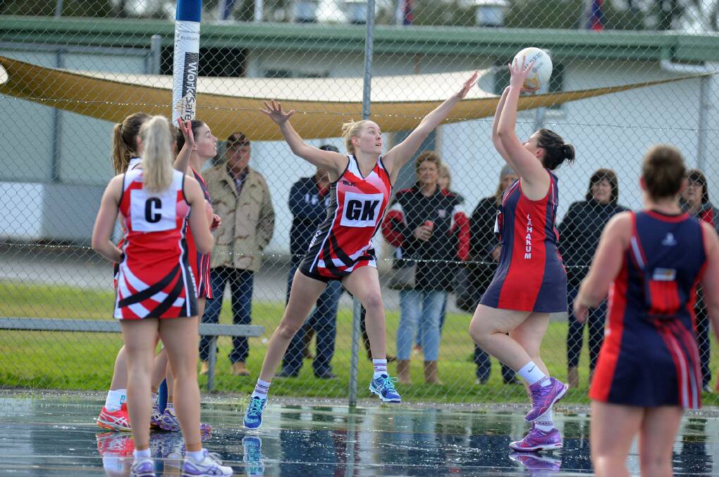 REACH: Laura McDonald in action for her netball team Edenhope-Apsley. She is now aiming to follow hers brothers Tom and Oscar into the AFL. Picture: PAUL CARRACHER