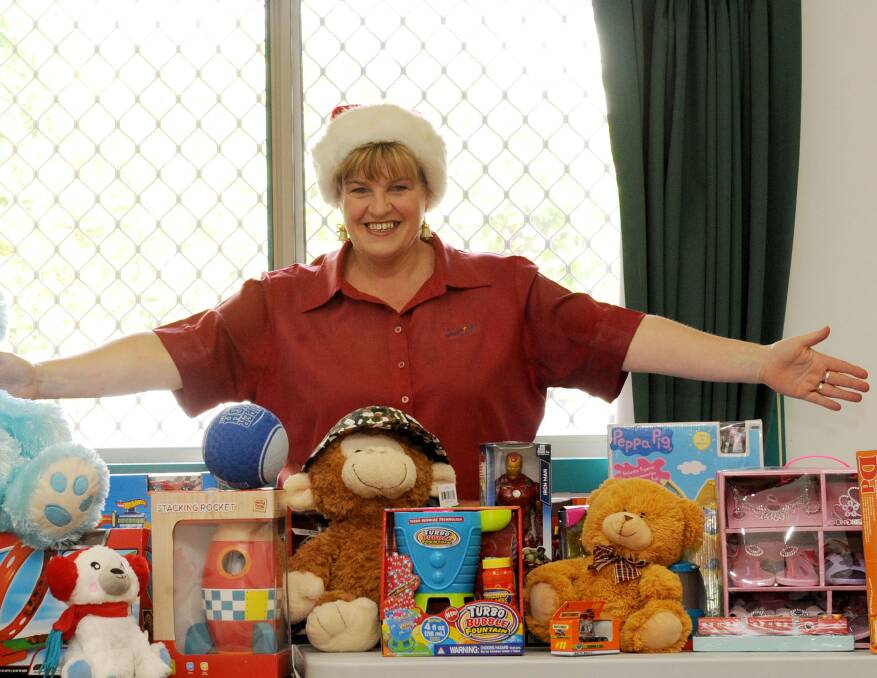 STOCKED UP: Salvation Army receptionist Raelene Johnston with gifts donated as part of the Salvation Army Christmas appeal. Picture: OLIVIA PAGE