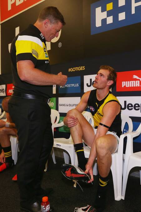 Tigers head coach Damien Hardwick speaks to David Astbury after their round one win against Carlton. Picture: Michael Dodge