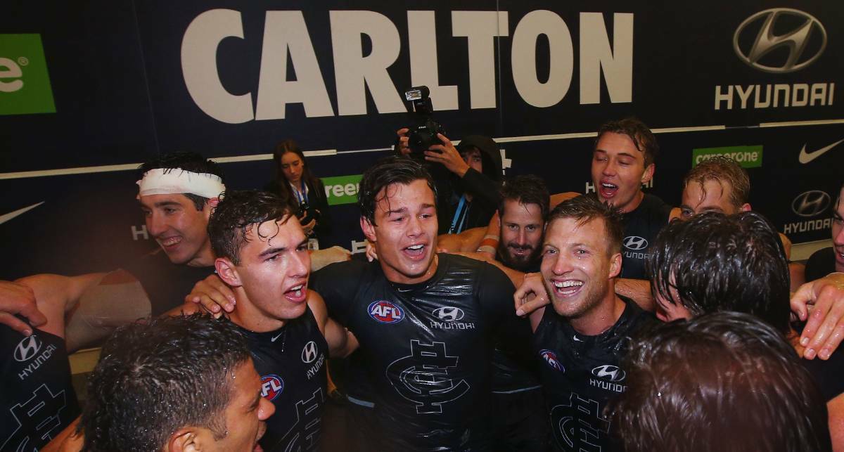 MEMORABLE: Ararat's Tom Williamson (left) sings the song to celebrate the Blues' narrow win against Essendon in April in his first AFL match. Picture: Getty Images
