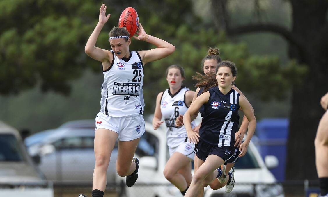HEADY PLAY: Georgia Clarke peforms a balancing act in this contest for possession in TAC Cup Girls on Sunday. Picture: Dylan Burns