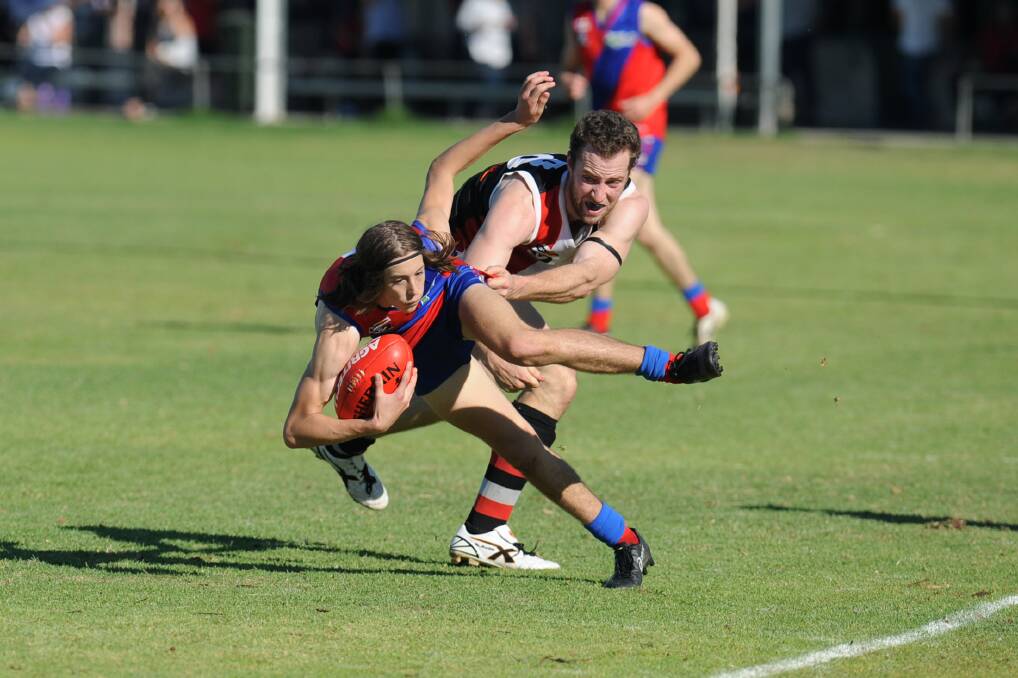 GOT HIM: Kalkee's Harvey Gunn tries to escape the clutches of his Edenhope-Apsley opponent in Jeremy Kealy. 