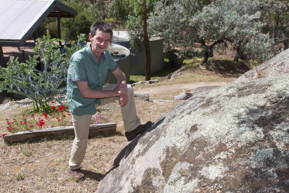 THAT WAS CLOSE: Black Range resident Keith Lofthouse at the scene of the slithering, where he came close to a brown snake on this very rock in his backyard. Picture: Peter Pickering 