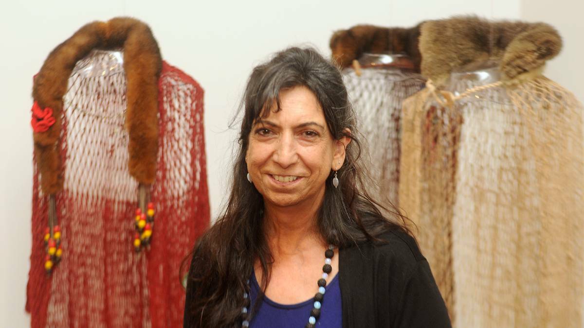 Indigenous artist Glenda Nicholls with her woven work A Woman's Rite to Passage. PHOTO: Nigel Clements.