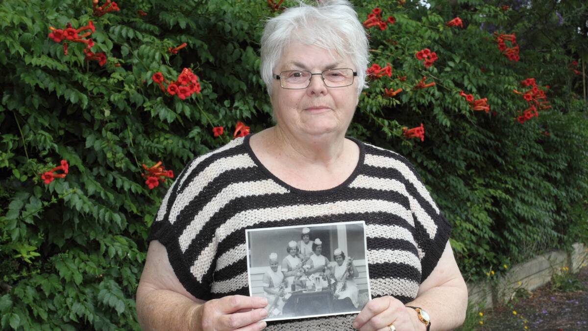 HALF CENTURY: Former EGHS enrolled nurse Doreen Lewis with a photo of her Horsham cadet nurse classmates from more than 50 years ago. Picture: PETER PICKERING 