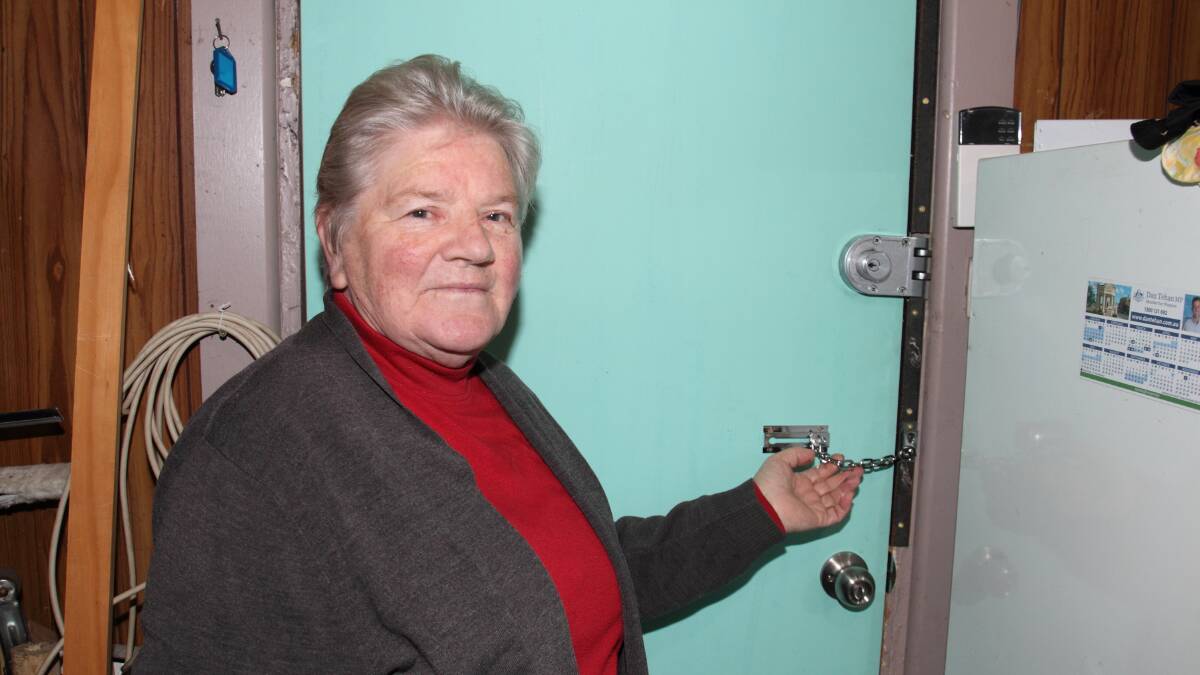 ENTRY: Narcissus Flowers & Gifts owner Wilma McAdie with the rear door to her shop that was forced open by thieves. Picture: PETER PICKERING