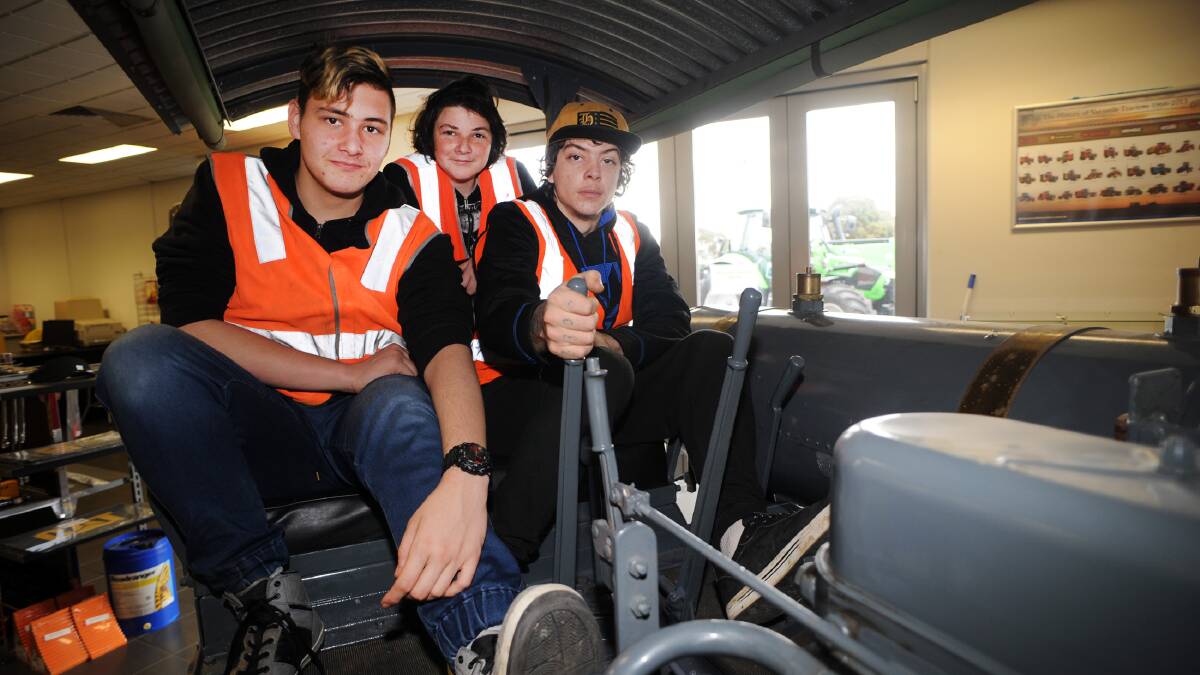 Horsham College ConnectEd students learning maths with a difference at William Adams CAT Horsham. Theo Maybery, Brett Smart and Tannar Blake try a 1927 CAT thirty track-type bulldozer.