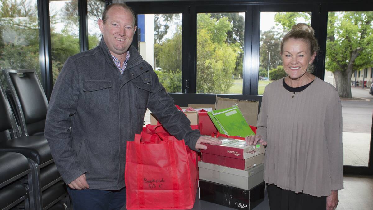 Ararat West Primary School principal Terry Keilar receives donated stationery from Ararat 800 Primary School principal Jennifer Molan. Picture: PETER PICKERING.