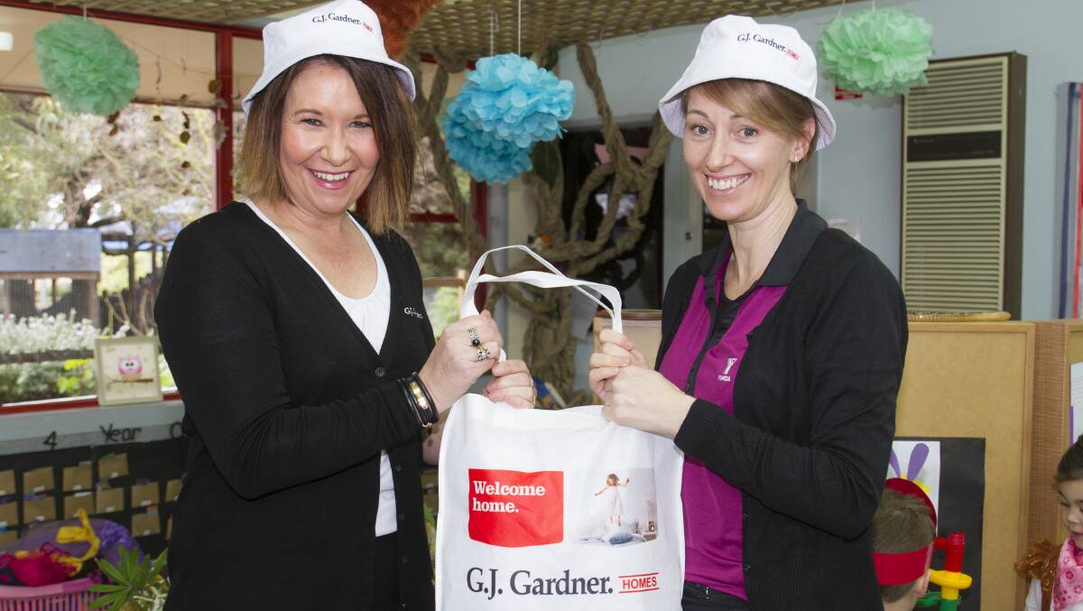 Sally Heard and Nerissa Gee with a donation of bucket hats to help keep kinder students Sun Smart. Picture: PETER PICKERING 